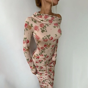 Close-up of ruched floral dress with vintage rose print and elegant draped neckline