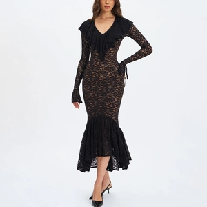 Detailed close-up of V-neck ruffle trim and floral lace texture on long-sleeve black dress