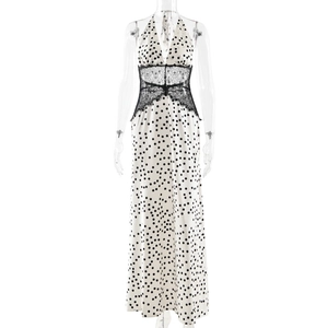 Detailed view of elegant black lace patchwork on a polka dot V-neck long dress