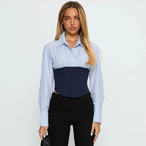 Detail showing waist-cinching corset design on a light blue striped long sleeve shirt