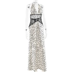 Detail view of the black lace waist patchwork on a white polka dot V-neck halter maxi dress