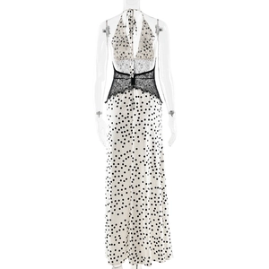 Detail view of the backless halter maxi dress with lace waist and black polka dot pattern
