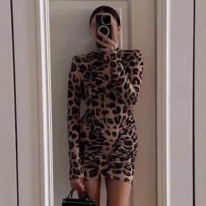 Close-up of ruched leopard print dress with a high neck and bodycon fit for women