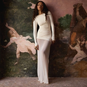 Elegant off-white backless bodycon dress with ruching detail and a floor-length silhouette