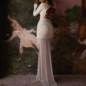 White backless bodycon maxi dress with side slit and sheer floor-length overlay