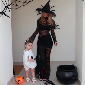Lace witch dress with flared sleeves and a white ghost costume with pumpkin props