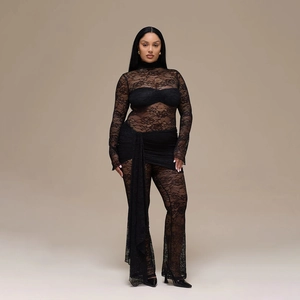 Close-up of intricate floral lace stitching and hollow out details on black long sleeve jumpsuit