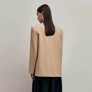 Macro detail of high-quality tailored back seam and shoulder line on khaki blazer