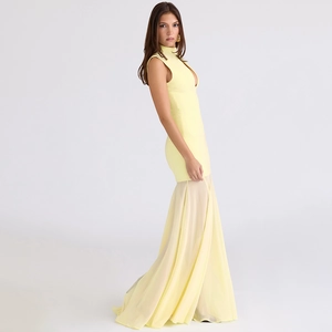 Detail of elegant pale yellow sleeveless dress featuring sheer chiffon mermaid hemline