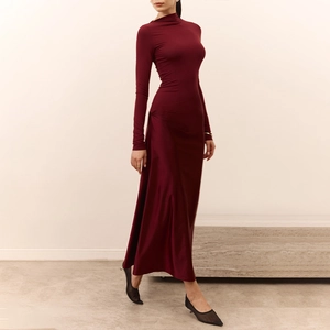 Detail showing waist pleats and soft drapes of a long sleeve wine red maxi dress