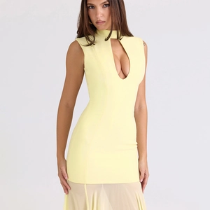 Detail of light yellow slim fit dress featuring halter neck and teardrop cutout at chest
