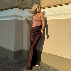 Detail of the nude halter top and brown satin fishtail skirt with waist pleats