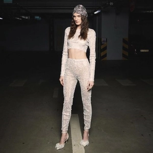 Full body shot of a sequined three-piece set featuring long-sleeve crop top and pants