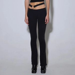 Close-up of low-waist ribbed pants with asymmetrical cutout and metal ring buckle