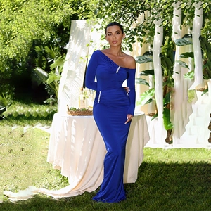 Detail of royal blue one-shoulder dress with rhinestone accents and ruched fabric