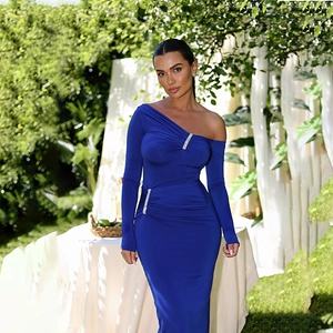 Detail of royal blue one-shoulder dress with rhinestone trim and ruched fabric texture