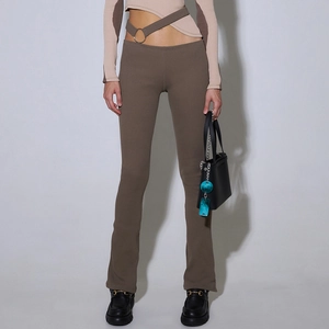 Detail view of dark brown ribbed knit pants featuring asymmetric waist cutout and metal ring