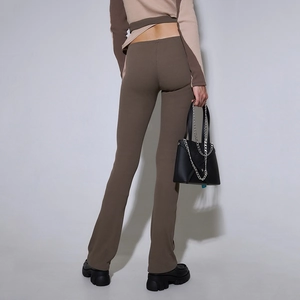 Detail shot of ribbed texture on high waist brown flare trousers and cropped top from behind