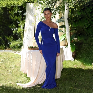 Detail of royal blue one-shoulder maxi dress with gathered waist and rhinestone trim