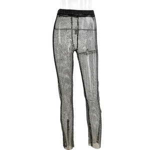 Detail of high waist black mesh trousers with sparkling rhinestones on fishnet fabric
