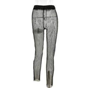 Detail view of black sheer mesh trousers with sparkling rhinestones for party wear