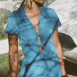 Women's vintage blue two-piece set featuring a short sleeve cardigan and matching skirt