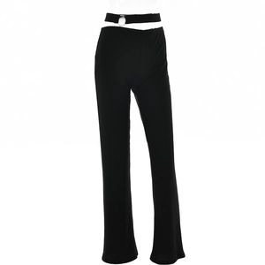 Detail of sexy low-waisted flared pants featuring side cut-outs and silver metal rings