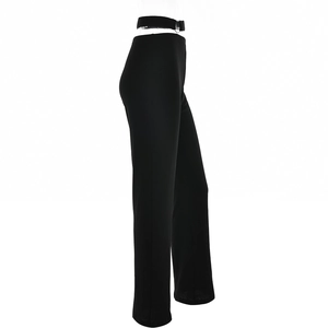 Detail of high waist black flared trousers with sexy cutout design and decorative strap
