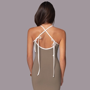 Detailed back view of bodycon dress showing white crisscross tie-up straps design