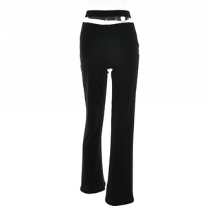 Detail of low waist flare pants featuring hollow cut-outs and silver metal ring accents