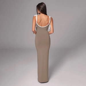 Close-up of khaki maxi dress showing white lace-up straps and deep low-back design