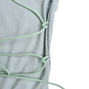 Vue macro du tissu en maille côtelée gris-vert avec un détail de laçage croisé