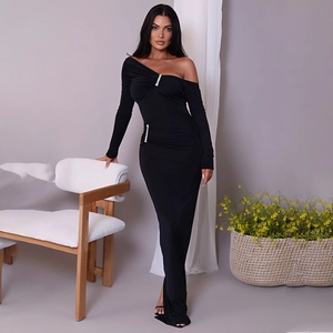 Detail of elegant black off-shoulder dress featuring sparkling rhinestone buckles on side