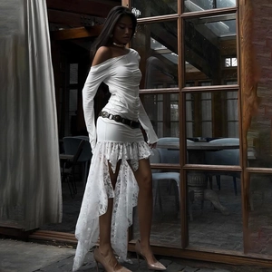 Detail of off-shoulder ruched dress with asymmetrical lace hem and decorative vintage belt