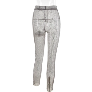 Close-up of silver rhinestone mesh trousers with shimmering see-through fabric detail