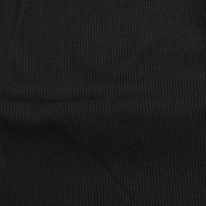 Macro shot of black ribbed knit fabric showing vertical texture and elastic material details