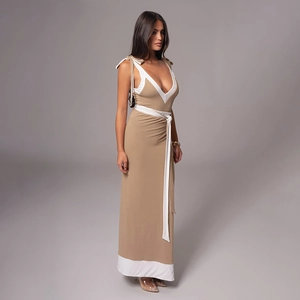 Detailed view of deep V-neck lace-up dress with white contrast trim and shoulder ribbons