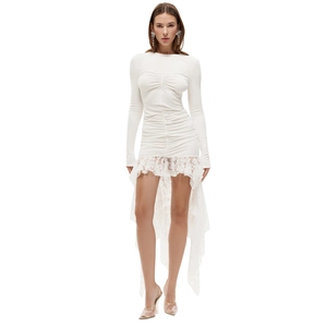 Detail of white ruched bodycon dress with long sleeves and floral lace fishtail hemline