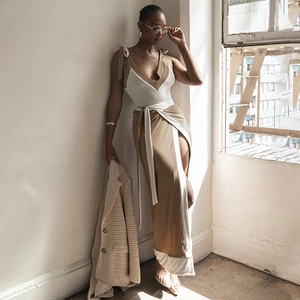 Detail of V-neck tie-shoulder dress with a high-slit skirt in white and khaki colors