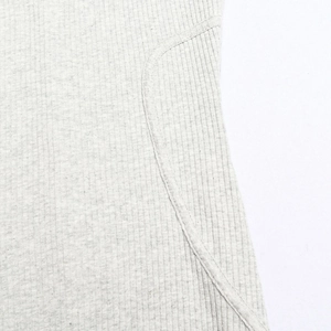 Macro shot of light gray ribbed knit fabric texture and high-quality curved stitching detail
