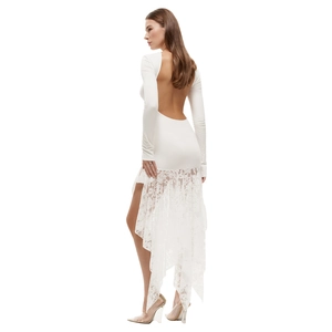 Detail of white backless mini dress with asymmetric floral lace hem and long sleeves