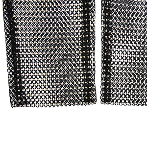 Detailed macro view of black mesh fabric with sparkling rainbow rhinestones