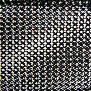 Detailed macro view of black mesh fabric with sparkling iridescent rhinestones on pants