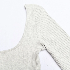 Detail of light grey ribbed knit fabric with U-neck design and clean shoulder stitching