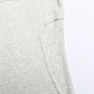 Detailed macro view of light gray ribbed fabric stitching and high-quality seam craftsmanship