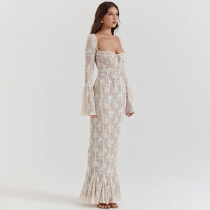 Detail of floral lace fabric with trumpet sleeves and ribbon bow on a slim fishtail dress