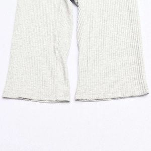 Detailed macro view of the marl grey ribbed knit hem on these long cotton trousers