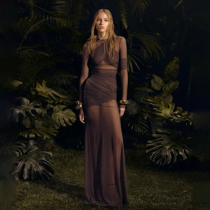 Detail of dark brown mesh maxi dress featuring sexy waist cutouts and ruching texture