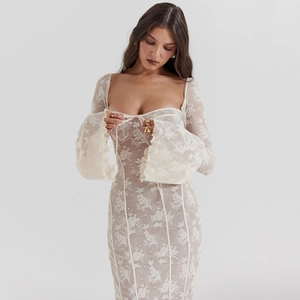Detailed view of floral lace texture on bodycon dress with flared sleeves