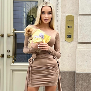 Detail of ruched waist design and decorative ribbons on a slim-fit khaki mini dress